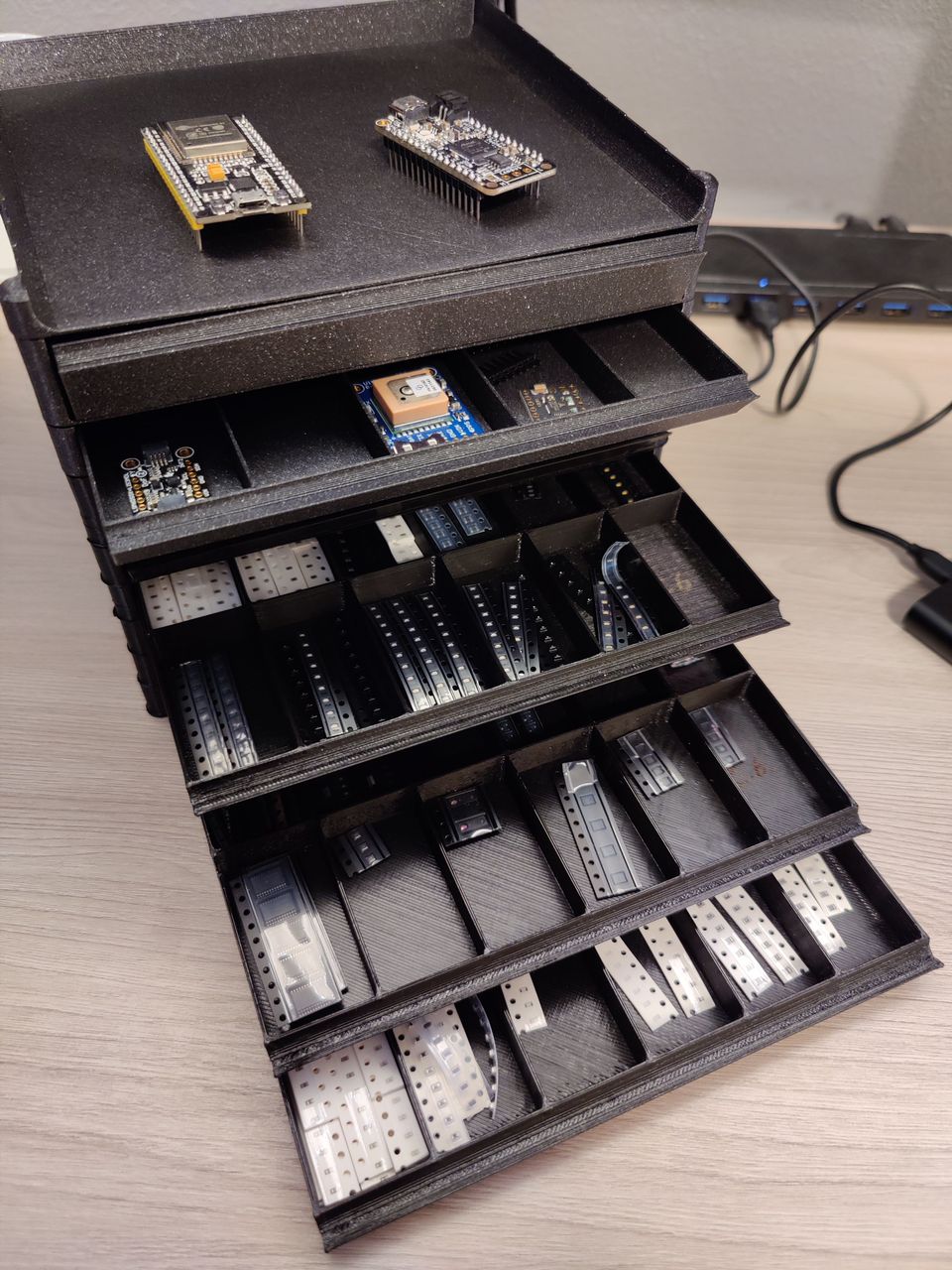 3D-printed storage system for small electronic components. Each drawer has a few sections for its own type of component